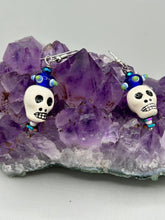 Load image into Gallery viewer, Spooky but festive Peruvian ceramic skull beads with hematite beaded spines and come with fiesta shaped crown glass earrings. These stylish skull earrings are perfect for adding a unique flair to any outfit. Whether you're looking for a Dia De Los Muertos accessory or simply looking to draw inspiration, these goth pieces perfectly capture the vampire goth, witchy, dark, Chingona Cabrona, Latina Chicana styles. Measurements: 1 1/4” in length