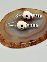 Load image into Gallery viewer, Spooky skull peruvian ceramic beads come with spine earrings. These stylish skull earrings are perfect for adding a unique flair to any outfit. Whether you're looking for a Dia De Los Muertos accessory or simply looking to draw inspiration, these goth pieces perfectly capture the vampire goth, witchy, dark, Chingona Cabrona, Latina Chicana styles. Measurements: 1 1/2” in length