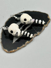 Load image into Gallery viewer, Spooky skull peruvian ceramic beads come with spine earrings. These stylish skull earrings are perfect for adding a unique flair to any outfit. Whether you're looking for a Dia De Los Muertos accessory or simply looking to draw inspiration, these goth pieces perfectly capture the vampire goth, witchy, dark, Chingona Cabrona, Latina Chicana styles. Measurements: 1 1/2” in length