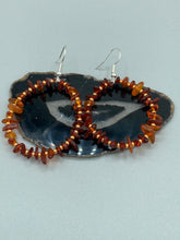 Load image into Gallery viewer, These hoop earrings feature natural amber stone chips and gold glass beads for an elegant, nature-inspired look. Measurements: 2" length and 2” in width