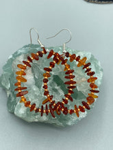 Load image into Gallery viewer, These hoop earrings feature natural amber stone chips and gold glass beads for an elegant, nature-inspired look. Measurements: 2" length and 2” in width