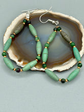 Load image into Gallery viewer, These stylish fish hook style earrings feature intricate beadwork crafted with forest green magnesite and ruby zoisite stones. Measurements: 2 3/4" length