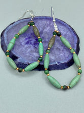 Load image into Gallery viewer, These stylish fish hook style earrings feature intricate beadwork crafted with forest green magnesite and ruby zoisite stones. Measurements: 2 3/4" length