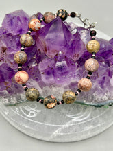 Load image into Gallery viewer, Nature inspired single-strand leopard jasper round stone beads with gold and black glass beaded bracelet. Leopard jasper stone has an array on neutral earth tones including soft pink, salmon, and gray tones. Crafted with metal wire and fastened with a lobster claw clasp. Measurements: Bracelet: 7 1/2" in length