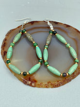 Load image into Gallery viewer, These stylish fish hook style earrings feature intricate beadwork crafted with forest green magnesite and ruby zoisite stones. Measurements: 2 3/4" length