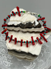 Load image into Gallery viewer, This distinctive Southwestern Style bracelet boasts a captivating combination of large red coral and blue-green turquoise glass beads for a visual impact. Crafted with metal wire and fastened with a lobster claw clasp, this bracelet is sure to command attention. Measurements: Bracelet: 8" in length