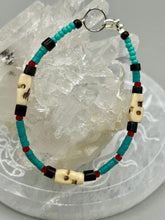 Load image into Gallery viewer, These stylish skull bracelet is perfect for adding a unique flair to any outfit. Whether you're looking for a Dia De Los Muertos accessory or simply looking to draw inspiration, these goth pieces perfectly capture the vampire goth, witchy, dark, Chingona Cabrona, Latina Chicana styles. Skull-shaped bone beads adorned with dark brown, turquoise, and gold beads make up this unique statement piece. Measurements: Bracelet: 7 1/2"