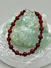 Load image into Gallery viewer, Single-strand dark red round glass beaded bracelet with dark red faceted crystals. Crafted with metal wire and fastened with a lobster claw clasp.  Measurements:   Bracelet: 8" in length