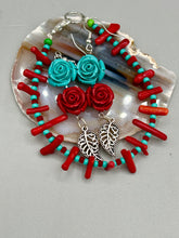 Load image into Gallery viewer, This alluring set of earrings captures the vibrant, enchanting beauty of the desert, featuring blue turquoise and bright red accents, highly detailed quartize rose beads and intricate silver plated leaf, providing fun movement. Perfect for those who love the Southwestern feel, Dia De Los Muertos, they can be dressed up or down, giving your fashion a unique touch. Measurements: 2” in length