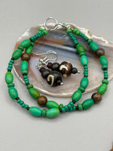 Load image into Gallery viewer, Mismatched round bone beads create an adaptable look when paired with neutral colors and wavy patterns, enabling wearers to tailor their ensembles in whatever way they desire. Measurements: 1 1/2 ” in length