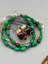Load image into Gallery viewer, Crafted with large and small round bone beads, these gold-tone floral metal bead earrings come in a range of neutral colors. Their versatile design allows them to transition easily from casual to formal, offering a unique edge to any ensemble. Measurements: 1 1/2 ” in length