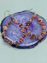 Load image into Gallery viewer, These pure rhodonite stone chip earrings with lustrous fuchsia and gold glass beading boast shimmering accents of blue, gold, and purple. Measurements: 2 1/4" length