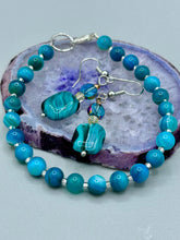 Load image into Gallery viewer, The Whimsical Teal Blue-Purple Glass Beaded Earrings feature a delightful mix of blues, purples, and hints of gold, along with varied sizes and shapes for an eye-catching textural look. The quartzite beads have a captivating swirl pattern, combining dark red and dark blue hues. Measurements: 1 1/2 ” in length