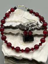 Load image into Gallery viewer, This eye-catching piece features two unconventional components: a large square-shaped black obsidian bead and a large, dark red glass bead. With the beautiful interplay of colors and shapes, these earrings are truly unique, yet at the same time, versatile enough to be paired with a range of styles.  Measurements: 1” in length