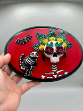 Load image into Gallery viewer, La Catrina y Gatita wall art is the purrfect hanging Day of the Dead art piece to add to your ofrenda. A tribute to an unbreakable bond and eternal love between cats and their guardians. Featuring a vibrant and intricate detail catrina and her floral crown and her kitty cat companion, this Day of the Dead-inspired artwork adds a little touch of Mexican art to your home or office. A unique handcrafted gift for any cat lover.