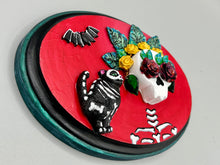 Load image into Gallery viewer, La Catrina y Gatita wall art is the purrfect hanging Day of the Dead art piece to add to your ofrenda. A tribute to an unbreakable bond and eternal love between cats and their guardians. Featuring a vibrant and intricate detail catrina and her floral crown and her kitty cat companion, this Day of the Dead-inspired artwork adds a little touch of Mexican art to your home or office. A unique handcrafted gift for any cat lover.