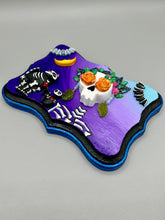 Load image into Gallery viewer, Frida Kahlo Inspired Wall Art | Dia De Los Muertos Home Decor. La Catrina y Gatita wall art is the purrfect hanging Day of the Dead art piece to add to your ofrenda. A tribute to an unbreakable bond and eternal love between cats and their guardians. Featuring a vibrant and intricate detail catrina and her floral crown and her kitty cat companion, this Day of the Dead-inspired artwork adds a little touch of Mexican art to your home or office. A unique handcrafted gift for any cat lover.