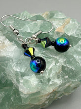 Load image into Gallery viewer, Elegantly crafted aurora borealis faceted glass beaded jewelry. These dainty earrings offer a versatile style that can effortlessly elevate any ensemble.  Measurements: 1” in length