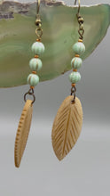 Load and play video in Gallery viewer, Bone Carved Leaf Charm Earrings, Light Mint Green Melon Czech Round Glass Beaded Earrings