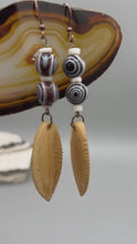 Load and play video in Gallery viewer, Bone Carved Leaf Charm Earrings, Black And White Swirly Eye-Dot Glass Beaded Earrings, Evil Eye