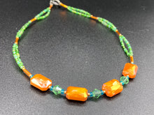 Load image into Gallery viewer, This unique, double-strand necklace consists of a blend of glass beads, including multi-green and rectangular, faceted orange glass beads, and is accented with gold and light blue elements. The vibrant combination is perfect for any summer look and will enhance any outfit.  Measurements:  Necklace is 16” and can be adjusted up to 18"