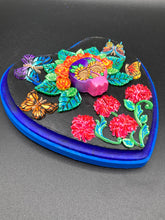 Load image into Gallery viewer, Frida Kahlo inspired calavera with a dark wood frame, this Day of the Dead wall decor piece is perfect for adding a traditional Mexican folk art touch to any home. Featuring an intricately detailed clay calavera in the style of Frida Kahlo, this Day of the Dead wall art decor is sure to be the centerpiece of any home décor. The calavera is wearing Frida's iconic crown of flowers and with several butterflies around her, ensuring it will bring both a unique and inspiring look to any wall.