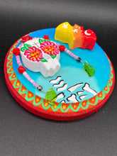 Load image into Gallery viewer, Transform your walls with this handcrafted polymer clay wall art. Showcasing a vibrant Frida Kahlo inspired calavera with hand-beaded floral crown, this Day of the Dead wall decor piece is perfect for adding a traditional Mexican folk art touch to any home.