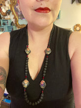 Load image into Gallery viewer, This statement necklace features elegant black matte glass beads with a smooth and velvety finish. Four ornamental ceramic beads with a traditional red, golden, and green pattern create a classic aura and luster-speckled dark red beads bring a striking final touch to the singular look.  This necklace is simple and elegant piece, very versatile look. Perfect cocktail chic attire, fancy wedding necklace, a minimalist look. Necklace: 32” in length  Necklace: 32” in length