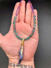 Load image into Gallery viewer, This necklace boasts a stunning Rainbow Kyanite wired stone pendant and two strands of shimmering glass beads. The blues contain hues of pink, gold, blue and green, offering a vibrant and bold addition to any jewelry collection. Measurements: Necklace is 17” in length, can be adjusted to 18"