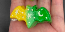 Load image into Gallery viewer, Cute and spooky magnet design to adorn your refrigerator, lockers, workstation, toolbox, or dishwasher. This hand-sculpted clay bat statuette boasts stunning ombre coloration, transitioning from to dark green to light green and then to bright yellow to recreate the breathtaking look of a starry night sky. H 1” x W 2” x D 1/2”