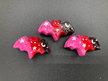 Load image into Gallery viewer, Cute and spooky magnet design to adorn your refrigerator, lockers, workstation, toolbox, or dishwasher. This hand-sculpted clay bat statuette boasts stunning ombre coloration, transitioning from black to dark red to pink to recreate the breathtaking look of a starry night sky. H 1” x W 2” x D 1/2”