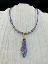 Load image into Gallery viewer, This Rainbow Kyanite Wired Stone Pendant features two strands of glass bead necklaces with a dazzling spectrum of colors, including purple, pink, gold, blue, and green. This bold piece of jewelry is guaranteed to add an eye-catching touch to any collection. Measurements: Necklace is 17” in length, can be adjusted to 18"