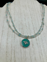 Load image into Gallery viewer, Make a statement with this dainty, yet bold Amazonite Bee Pendant Necklace. Beautifully beaded with frosty glass in blue and silver tones, this shabby chic jewelry piece complements any outfit. The perfect combination of hues and shapes will add complexity and elegance to your look. Measurements: Necklace is 17” in length
