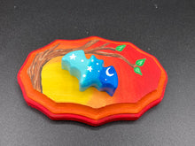 Load image into Gallery viewer, This unique Starry Night Mini Bat Wall Art Decor is hand sculpted and painted in vivid hues to offer an eye-catching decoration for your living space. The bat is painted in a gradient of light to dark blue, and is complemented by white stars and a crescent moon. The wood frame is painted in yellow, orange and red for a stunning sundown effect for a drastic contrast to the blue bat.