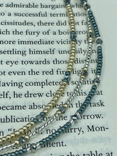 Load image into Gallery viewer, This stylish necklace features a silver plated metal octopus pendant and vibrant iridescent and silver-gray glass beads of various sizes. The Steampunk-inspired design provides a textured, patterned and voluminous look perfect for any dark goth or witchy aesthetic. Measurements: Necklace measures 15 1/2” adjustable up to 17” in length