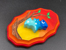 Load image into Gallery viewer, This unique Starry Night Mini Bat Wall Art Decor is hand sculpted and painted in vivid hues to offer an eye-catching decoration for your living space. The bat is painted in a gradient of light to dark blue, and is complemented by white stars and a crescent moon. The wood frame is painted in yellow, orange and red for a stunning sundown effect for a drastic contrast to the blue bat.