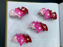Load image into Gallery viewer, Cute and spooky magnet design to adorn your refrigerator, lockers, workstation, toolbox, or dishwasher. This hand-sculpted clay bat statuette boasts stunning ombre coloration, transitioning from dark red to light pink to recreate the breathtaking look of a starry night sky. H 1” x W 2” x D 1/2”