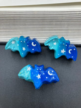 Load image into Gallery viewer, Cute and spooky magnet design to adorn your refrigerator, lockers, workstation, toolbox, or dishwasher. This hand-sculpted clay bat statuette boasts stunning ombre coloration, transitioning from dark blue to light blue to recreate the breathtaking look of a starry night sky. H 1” x W 2” x D 1/2”