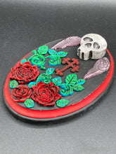 Load image into Gallery viewer, This Memento Mori Wall Art Decor is a one-of-a-kind art piece, skillfully crafted with a black polymer clay skull and wings on a dark red wood frame, decoratively woven with dark red roses and vines. It's perfect for adding an eye-catching touch to any wall and makes a unique, bold gift.  Measurements: H 7" x W 5” x D 1 1/2"