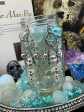 Load image into Gallery viewer, Day of The Dead, La Catrina Dia De Los Muertos Aretes, Pastel Goth Jewelry, Dangling Skulls Silver Cross Beaded Chandelier Style Earrings