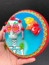 Load image into Gallery viewer, Transform your walls with this handcrafted polymer clay wall art. Showcasing a vibrant Frida Kahlo inspired calavera with hand-beaded floral crown, this Day of the Dead wall decor piece is perfect for adding a traditional Mexican folk art touch to any home.