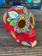 Load image into Gallery viewer, This uniquely handpainted ceramic skull is inspired by the beauty of Sedona, AZ. Features bold fire red color with nature-inspired design for a truly one-of-a-kind mini calavera. Perfect for adding a southwestern touch to your Dia de Los Muertos ofrenda. Measurements: H 4” x W 4” x D 5 1/2”
