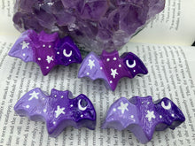Load image into Gallery viewer, Cute and spooky magnet design to adorn your refrigerator, lockers, workstation, toolbox, or dishwasher. This hand-sculpted clay bat statuette boasts stunning ombre coloration, transitioning from dark purple to light purple to recreate the breathtaking look of a starry night sky. H 1” x W 2” x D 1/2”