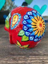 Load image into Gallery viewer, This uniquely handpainted ceramic skull is inspired by the beauty of Sedona, AZ. Features bold fire red color with nature-inspired design for a truly one-of-a-kind mini calavera. Perfect for adding a southwestern touch to your Dia de Los Muertos ofrenda. Measurements: H 4” x W 4” x D 5 1/2”