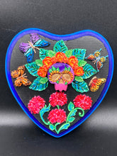 Load image into Gallery viewer, Frida Kahlo inspired calavera with a dark wood frame, this Day of the Dead wall decor piece is perfect for adding a traditional Mexican folk art touch to any home. Featuring an intricately detailed clay calavera in the style of Frida Kahlo, this Day of the Dead wall art decor is sure to be the centerpiece of any home décor. The calavera is wearing Frida's iconic crown of flowers and with several butterflies around her, ensuring it will bring both a unique and inspiring look to any wall.