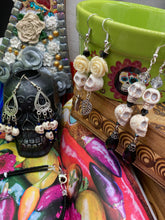 Load image into Gallery viewer, This luxurious design features two large howlite skull beads and a large black teardrop shaped glass bead; perfect for achieving a Chingona, Cabrona, Latina Chicana, Goth, Vampire Goth, Dark Witchy, La Bruja look. This statement jewelry will add a unique touch to any outfit.
