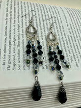 Load image into Gallery viewer, This stylish three-strand black and silver glass beaded earring design presents a beautiful dancing effect, boasting a large black teardrop glass bead. A versatile accessory, it suits a variety of ensembles from cocktail chic to wedding fineries, and its minimalist aesthetic lends a modern charm.  Measurements: 3 3/4” in length