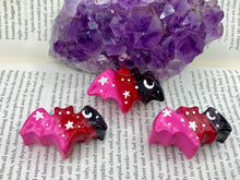 Load image into Gallery viewer, Cute and spooky magnet design to adorn your refrigerator, lockers, workstation, toolbox, or dishwasher. This hand-sculpted clay bat statuette boasts stunning ombre coloration, transitioning from black to dark red to pink to recreate the breathtaking look of a starry night sky. H 1” x W 2” x D 1/2”