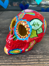 Load image into Gallery viewer, This uniquely handpainted ceramic skull is inspired by the beauty of Sedona, AZ. Features bold fire red color with nature-inspired design for a truly one-of-a-kind mini calavera. Perfect for adding a southwestern touch to your Dia de Los Muertos ofrenda. Measurements: H 4” x W 4” x D 5 1/2”