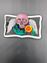 Load image into Gallery viewer, This unique wall art decor, crafted with hand-molded polymere clay and painted on a wooden frame, brings to life a classic Dia De Los Muertos Calavera with its fiery-red skull and bright yellow-orange flower and vine accents. Perfect for accenting your crystal display, witchy altar, or indoor garden.